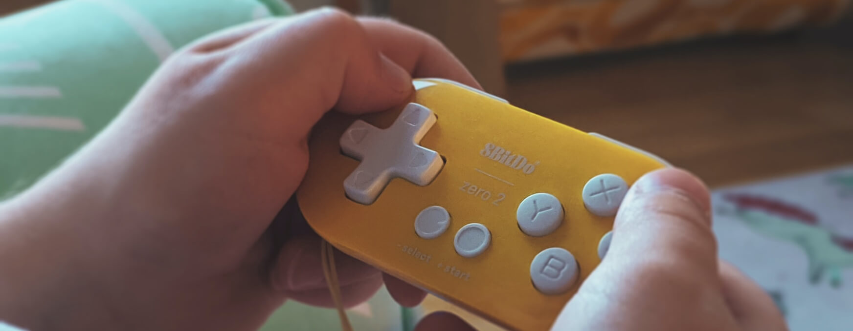 the image shows a child's hands playing on a Nintendo device to reflect our free gaming support group for children impacted by mental health needs.
